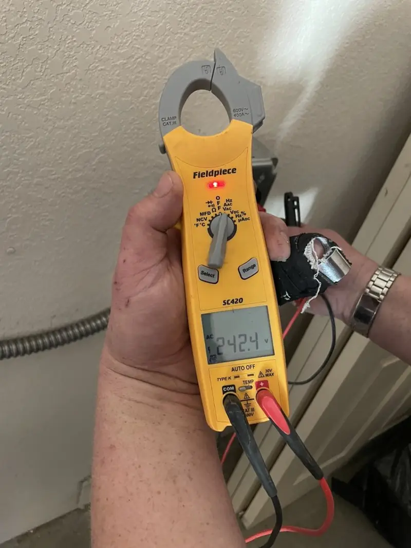 Voltage testing with clamp meter during Ceiling Fan Installation in Baldwin